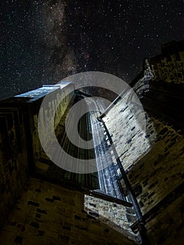 Upwards shot of historic Teyn church in Prague at night with stars visible