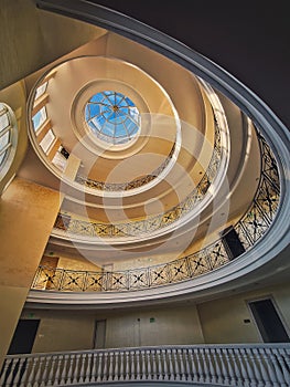 Upwards view architecture interior details of a big round storied hall with glass dome