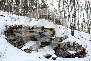 In the Ural mountains, in the forest, stone, moss, snow.