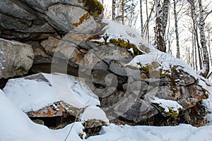 In the Ural mountains, in the forest, stone, moss, snow.