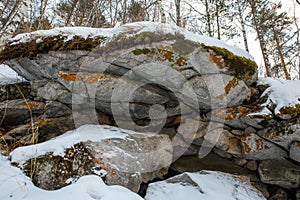 In the Ural mountains, in the forest, stone, moss, snow.