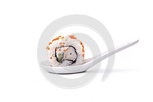 Uramaki on cucchiao on white background
