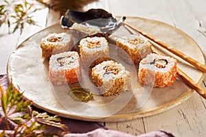 Uramaki sushi rolls on a rustic pottery plate
