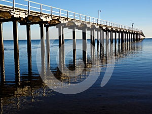Urangan Pier and Reflection on clear blue skies and sea photo
