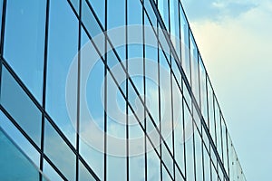 Urban abstract background, detail of modern glass facade, office business building.