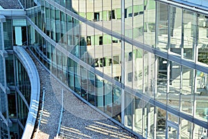 Urban abstract background, detail of modern glass facade, office business building.