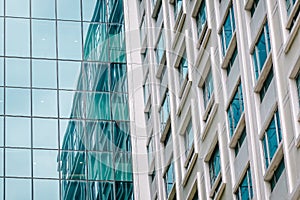 Urban abstract - Close-up of modern city glass curtain wall, windowed corner of office building photo