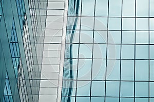 Urban abstract - Close-up of modern city glass curtain wall, windowed corner of office building photo