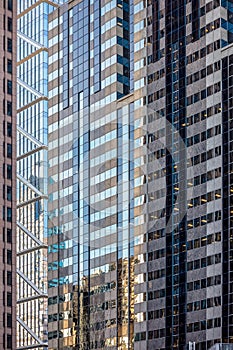 Urban abstract: window facade of a downtown office building with reflections and colors.