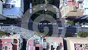 Urban aerial view of road towards intersection showing urban roads crossing each other traffic driving over roads and