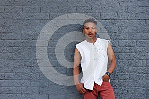 Urban african man leaning against gray wall