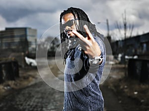 Urban african man showing peace sign.