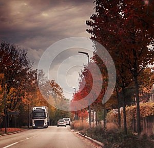 Urban alley with traffic, autumnal view