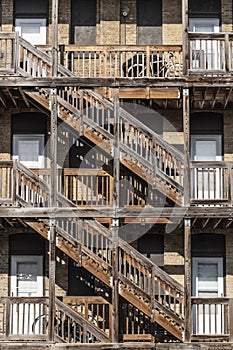 Urban apartment multi-unit dwelling with side-by-side units stacked on top of each other separated by a wood frame