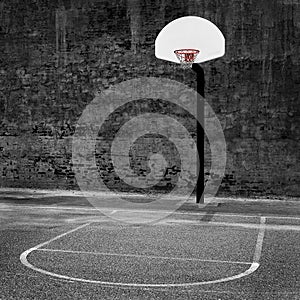 Urban basketball hoop inner city innercity wall and asphalt in outdoor park