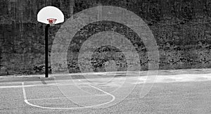 Urban basketball hoop inner city innercity wall and asphalt in outdoor park grunge brick