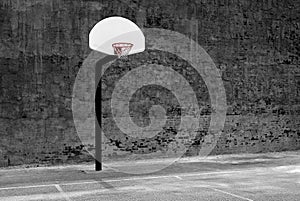 Urban Basketball Hoop Inner City Wall and Asphalt