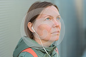 Urban brisk walker female listening music on earphones