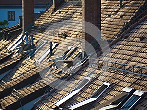 Urban buildings with  brown tile rooftops  chimneys and windows