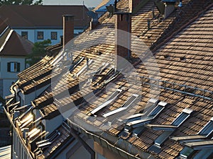 Urban buildings with  brown tile rooftops  chimneys and windows