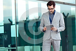 Urban business man with laptop outside in airport