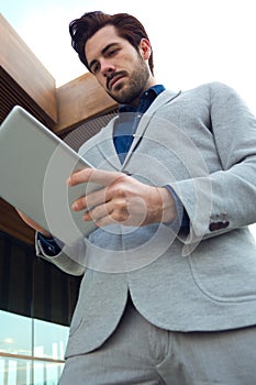 Urban business man with laptop outside in airport