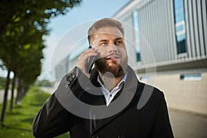 Urban business man talking smart phone traveling walking outside airport