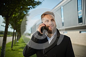 Urban business man talking smart phone traveling walking outside airport