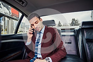 Urban businessman driving in a limo