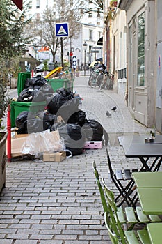 urban cafe set next to garbage and waste bursting over