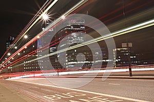 Urban city night shot on London Bridge, Red Bus in Motion, long exposure shot
