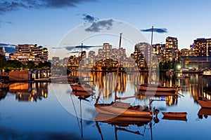 Urban city night, Vancouver twilight skyline. Boats on the False Creek