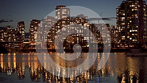 Urban city night, Vancouver twilight skyline. Buildings lights reflection