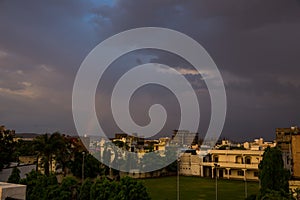 Urban city scape on rainy day with beautiful clouds and a thin rainbow