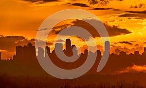 Urban cityscape silhouette on sunset sky background