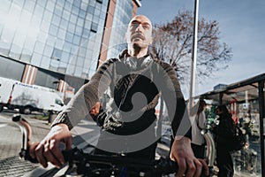 Urban cyclist commuting in the city, confident man riding bicycle