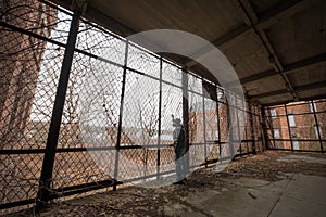 Urban explorer looking out of a cage