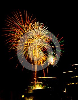 Urban firework celebration on lighted roof tops