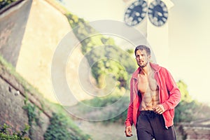 Urban fitness man jogging along the famous Clock Petrovaradin fortress