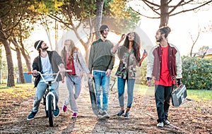 Urban friends gang walking in city skatepark on sunset backlight - Youth and millenial friendship concept photo