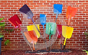 Urban garden display of painted shovels