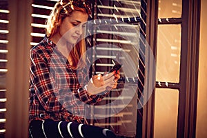 Urban girl holding a cellphone and texting messaging