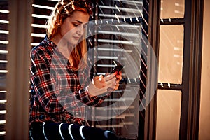 Urban girl holding a cellphone and texting messaging