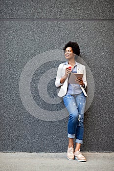 Urban happy business woman using tablet computer and working