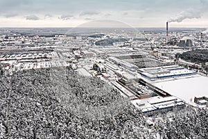 urban industrial area in winter. factory buildings  warehouses and thermal power plant on gray sky background. aerial view