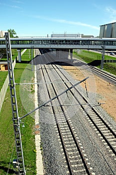 Urban industrial landscape railroad tracks and platform on sunny summer day