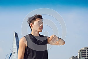 Urban jogger on rooftop his running time