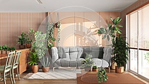 Urban jungle, kitchen and living room in white and orange tones. Dining table, parquet floor and houseplants. Home garden interior