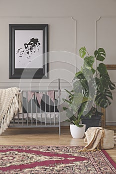 Urban jungle in mid century baby room interior