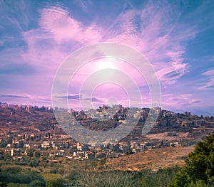 Panoramic view of small town on mount at sunset. Lebanon, Western Asia